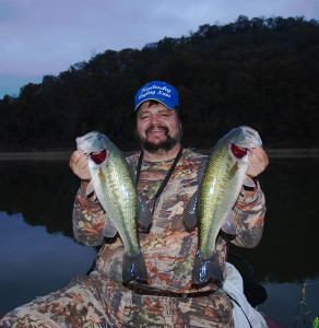 Author Chris Erwin holding a  pair of 18 inch bass caught on Cave Run Oct. 29. (Photo by Hershell Crum). 